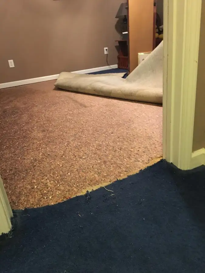 Carpet pad removal revealing water damage during Water Mitigation Services in East Wenatchee